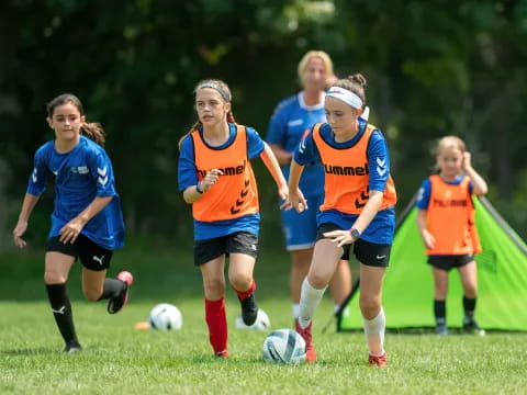 girls playing football on a field