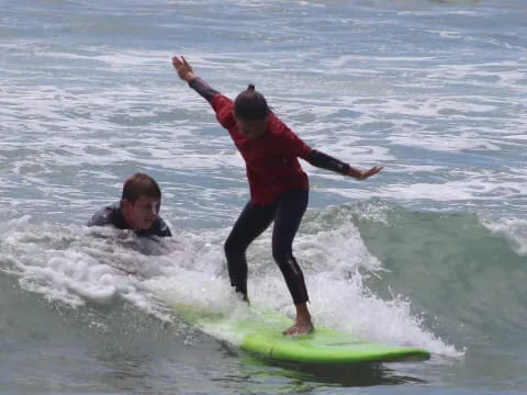 a man and a boy surfing