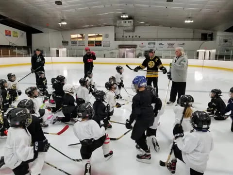 a group of people wearing helmets and kneeling on ice