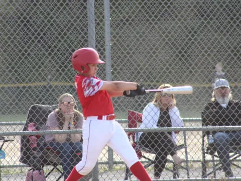 a baseball player swinging a bat