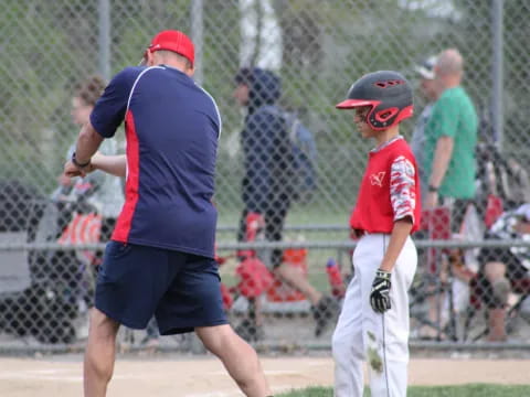 a person and a boy playing baseball