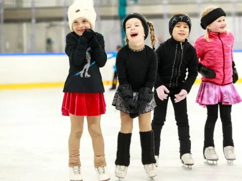 a group of girls wearing ice skates and ice skates