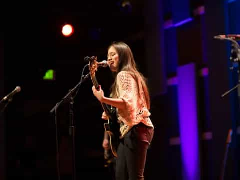 a person singing into a microphone