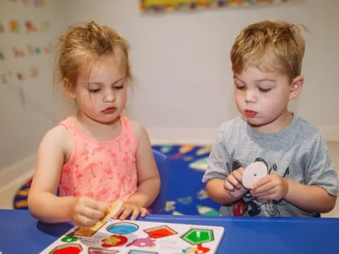 a couple of kids playing with a toy