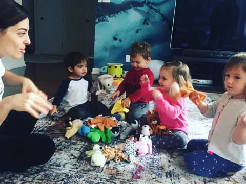 a group of children sitting on the floor with toys