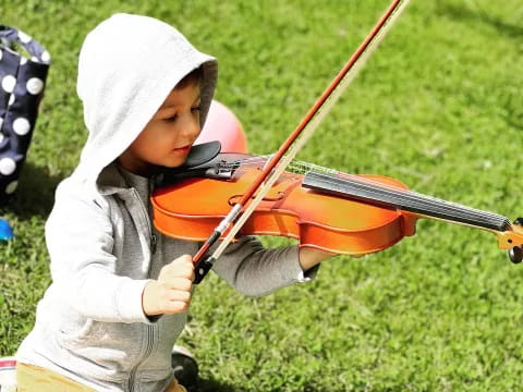 a young boy playing a violin