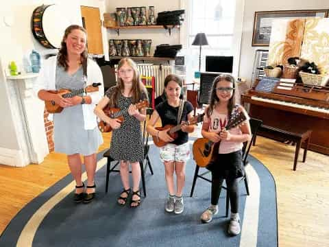 a group of women holding musical instruments