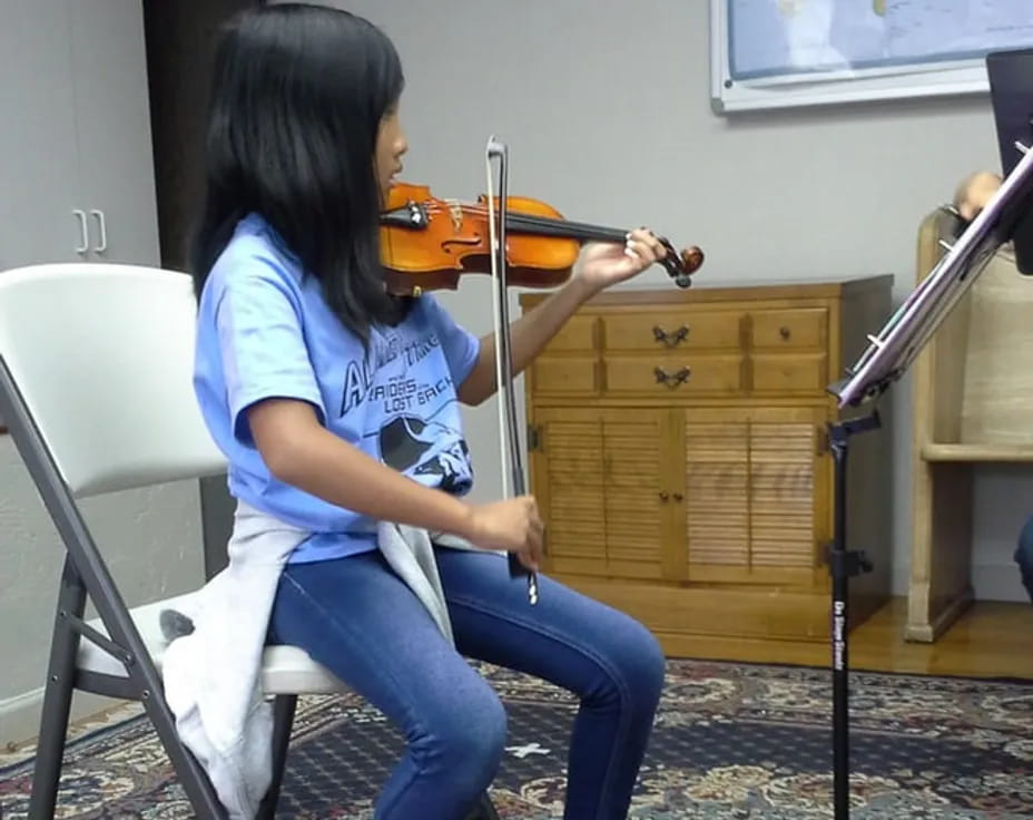 a woman playing a violin