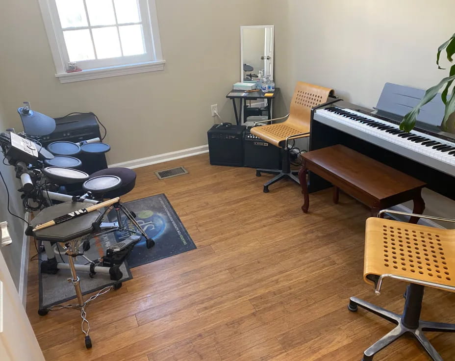 a room with a piano and chairs