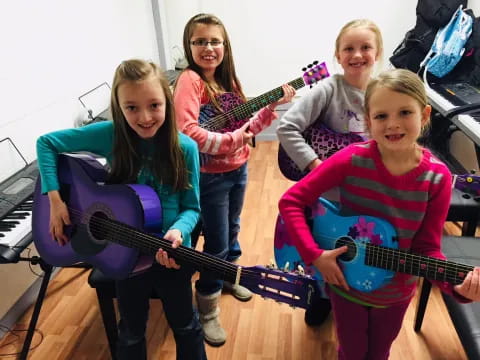 a group of girls holding guitars