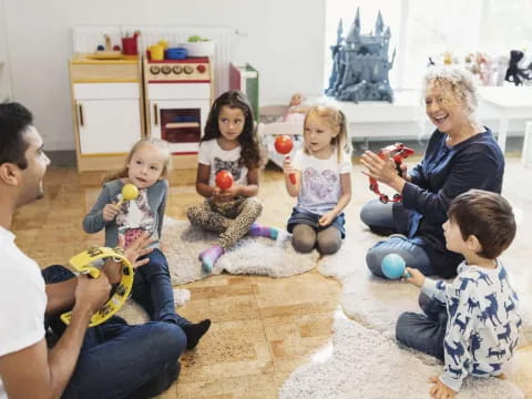 a group of people sitting on the floor with a person and children