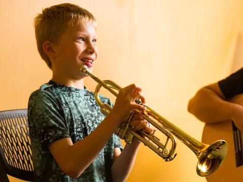 a boy playing a trumpet