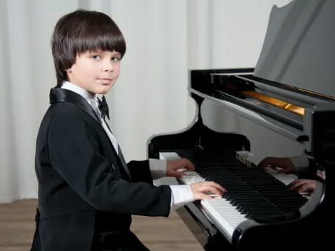 a boy playing a piano