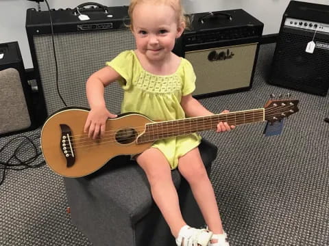 a child holding a guitar