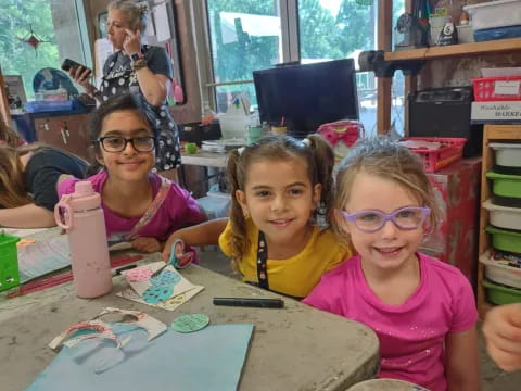 a group of children sitting at a table