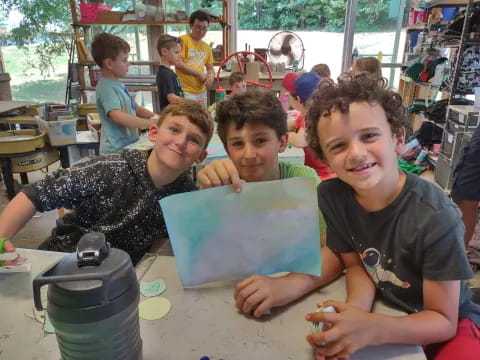 a group of children sitting at a table