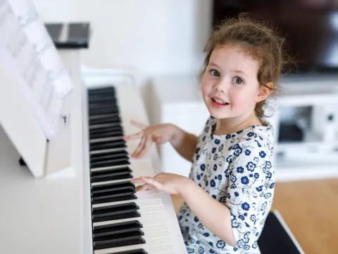 a little girl playing piano