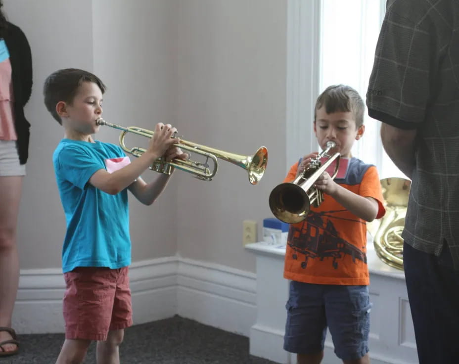 a boy playing a trumpet