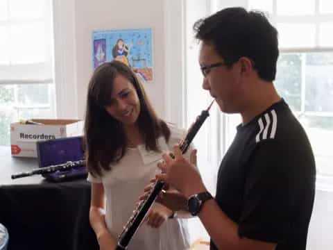a man and a woman playing a flute