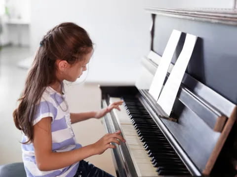 a girl playing a piano