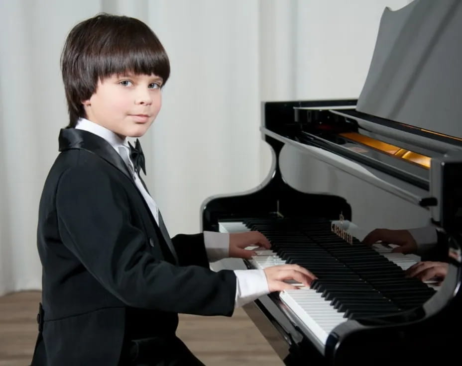 a boy playing a piano