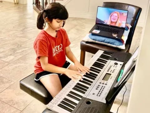 a girl playing a piano