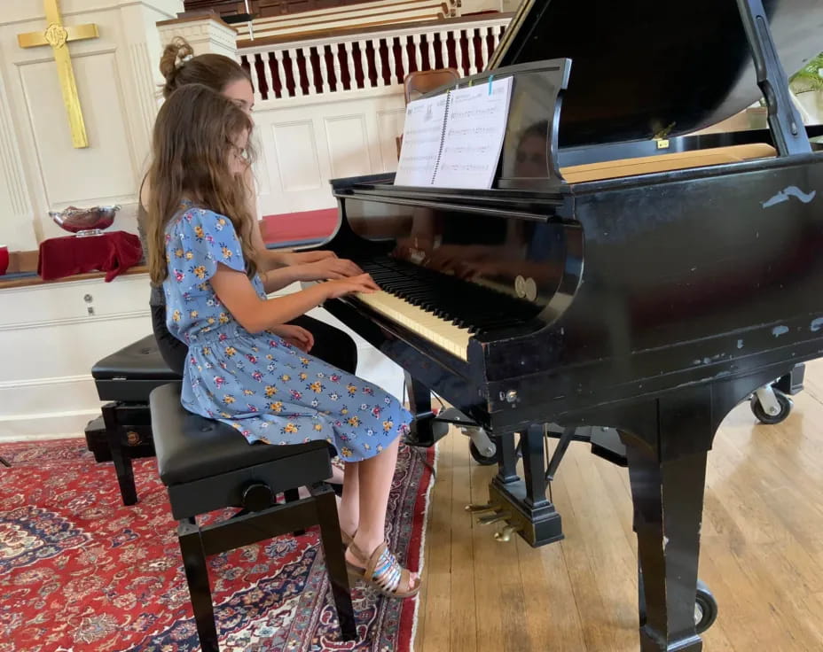 a girl playing a piano