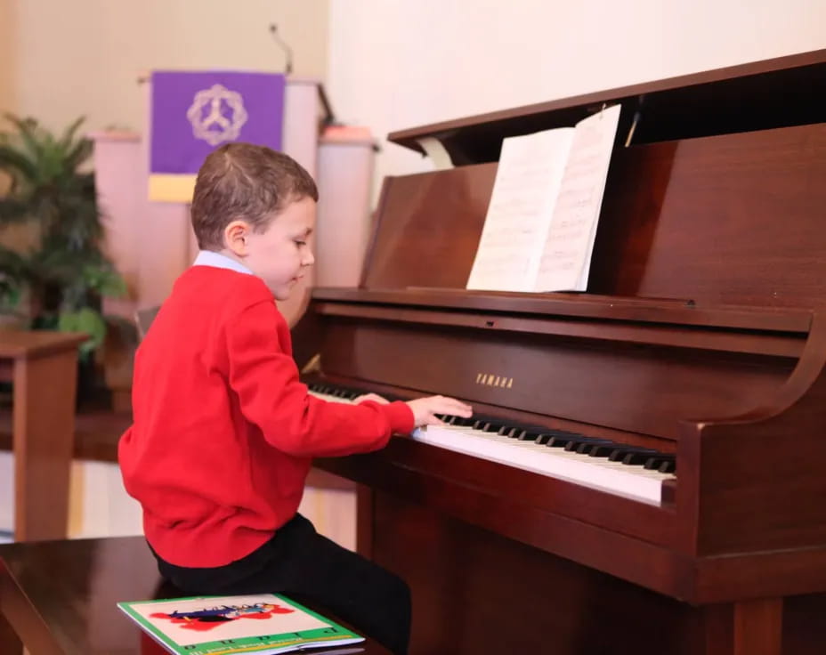 a boy playing a piano