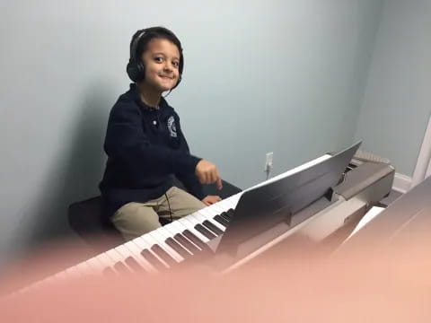 a person sitting on a piano