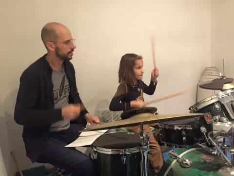 a man and a woman playing drums