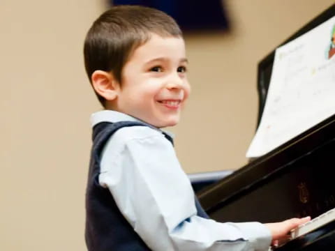 a boy playing a piano