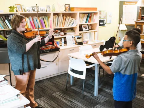 a man playing a guitar next to a woman playing a piano