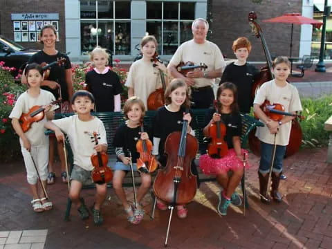 a group of people posing for a photo with musical instruments