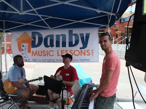 a group of men playing instruments under a tent