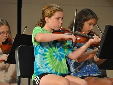 a group of women playing violin