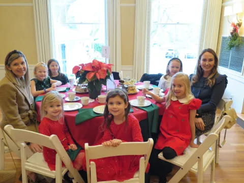 a group of people sitting around a table