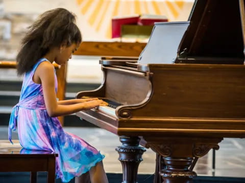 a girl playing a piano