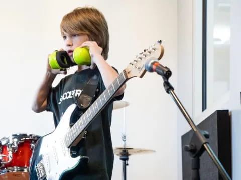 a boy playing a guitar