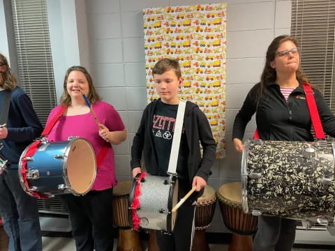 a group of people holding drums