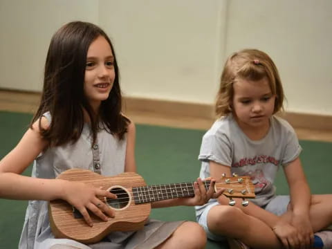 a person and a child playing guitar