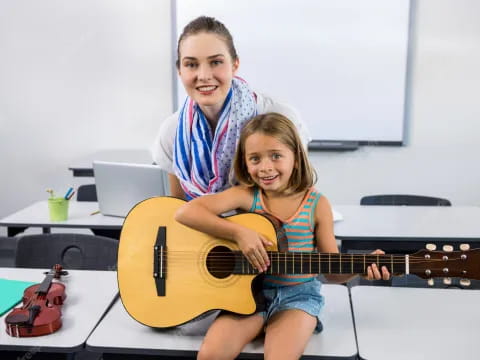 a person and a girl playing a guitar