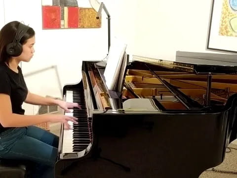 a woman playing a piano