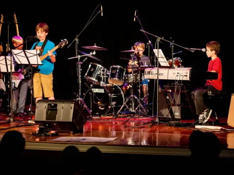 a group of people playing instruments on a stage