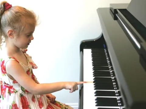 a little girl playing piano