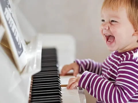 a baby playing piano