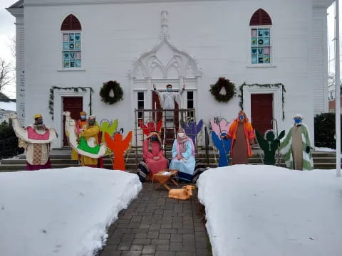 a group of people in clothing outside a house