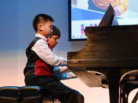 a man and woman playing piano