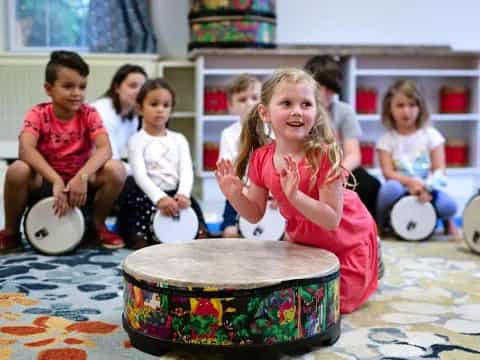 a group of children playing drums