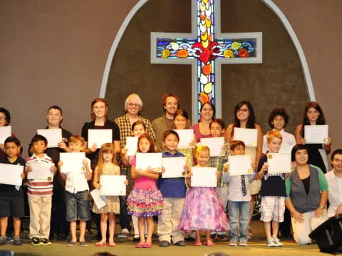 a group of people holding certificates