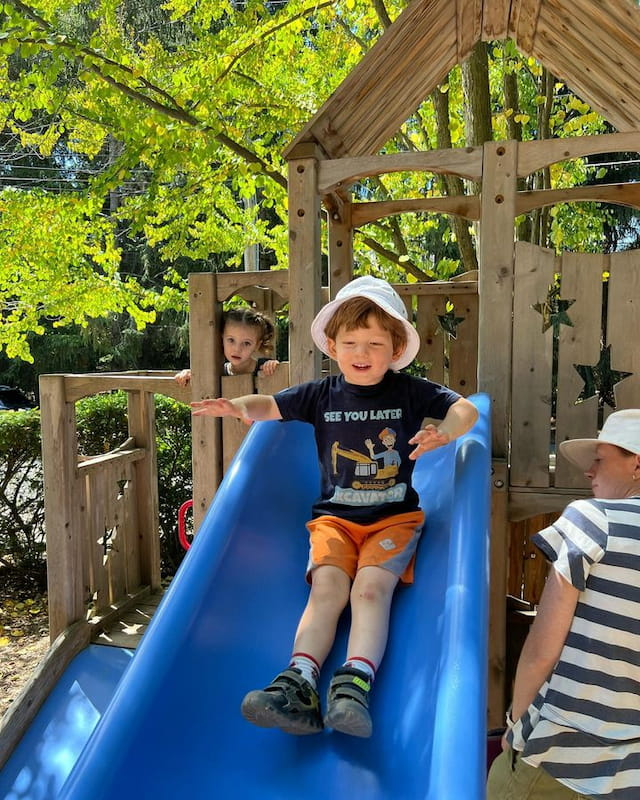 a boy sitting on a slide